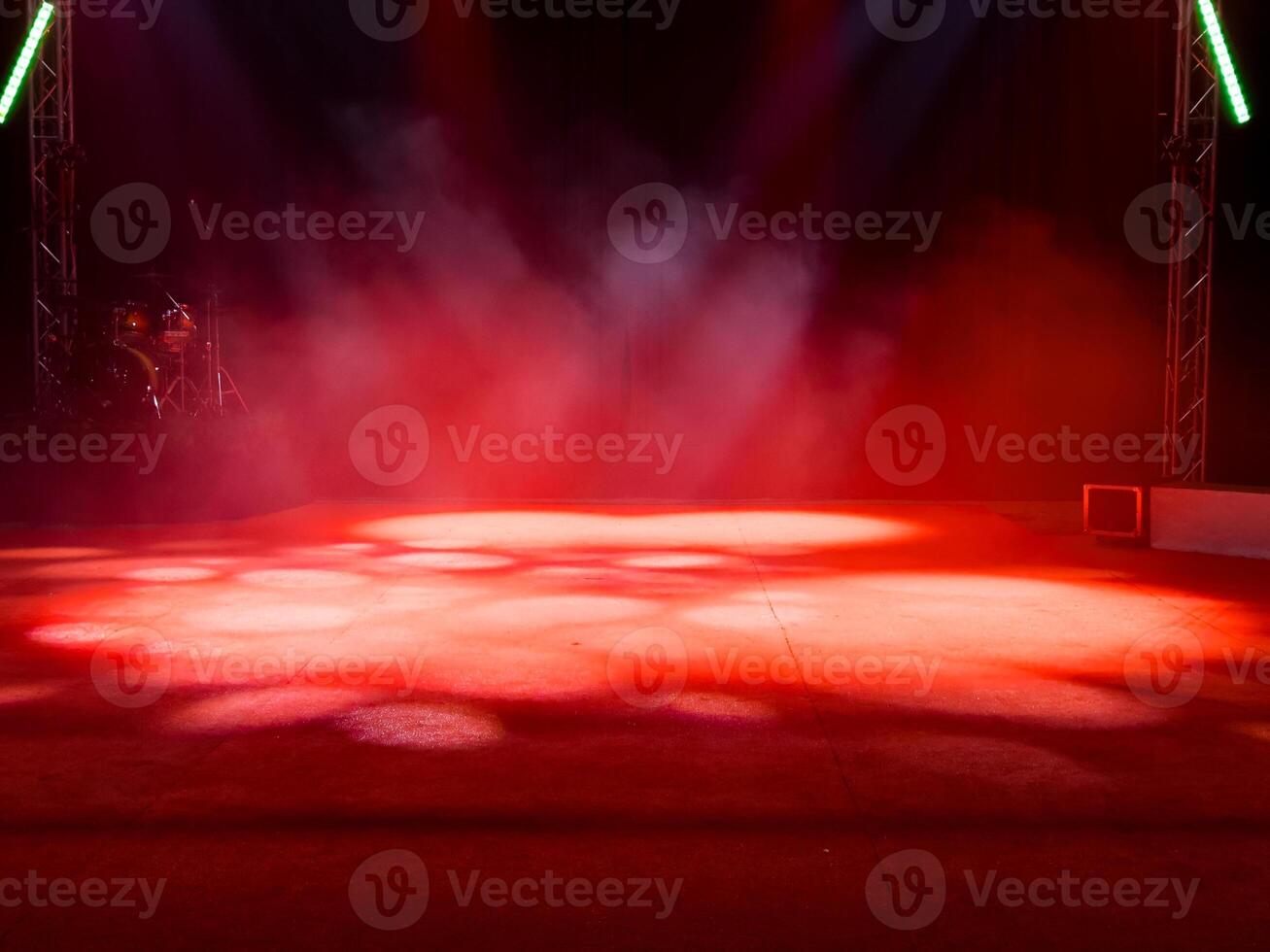 Empty stage with red lights and smoke effects in theater setting photo