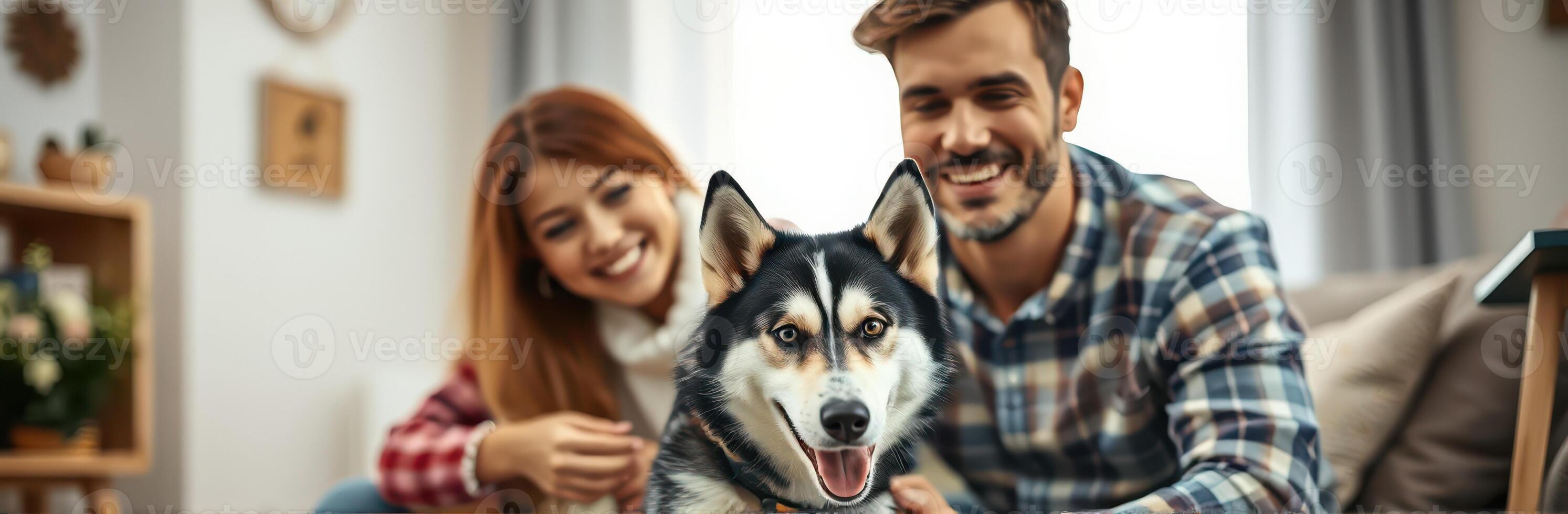 Happy couple spending quality time with a playful husky in a cozy living room on a sunny afternoon photo