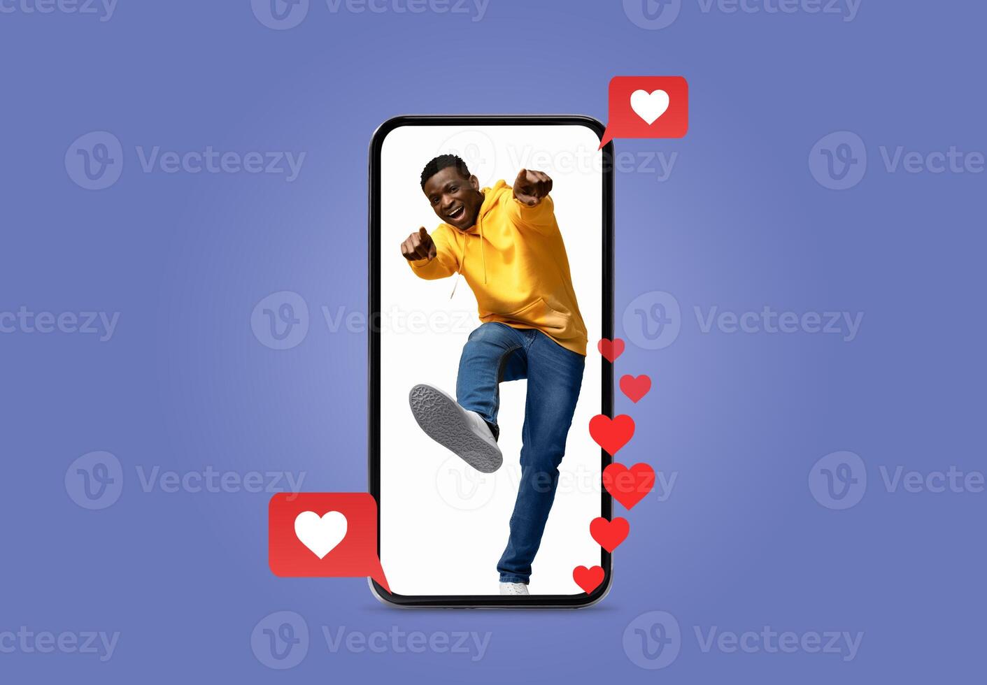 A person wearing a yellow sweatshirt enthusiastically uses a smartphone, surrounded by heart icons symbolizing love and engagement in social media, perfect for Valentine's Day themes. photo