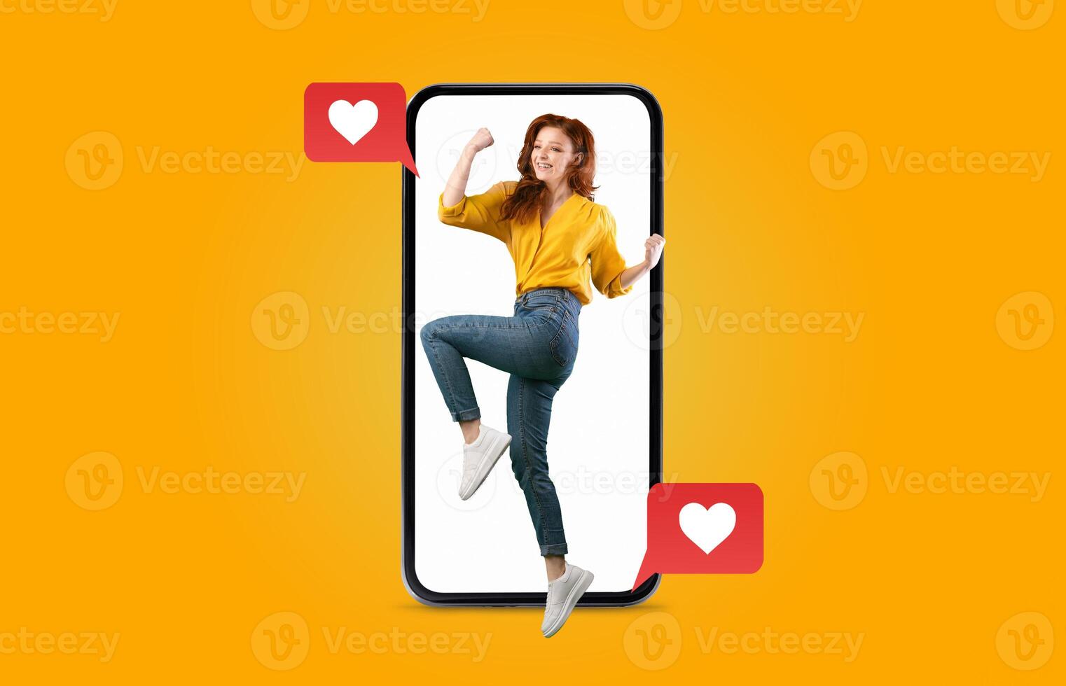 A young woman enthusiastically interacts with a smartphone displaying heart emojis, symbolizing connection and affection. This vibrant scene emphasizes modern dating and communication. photo