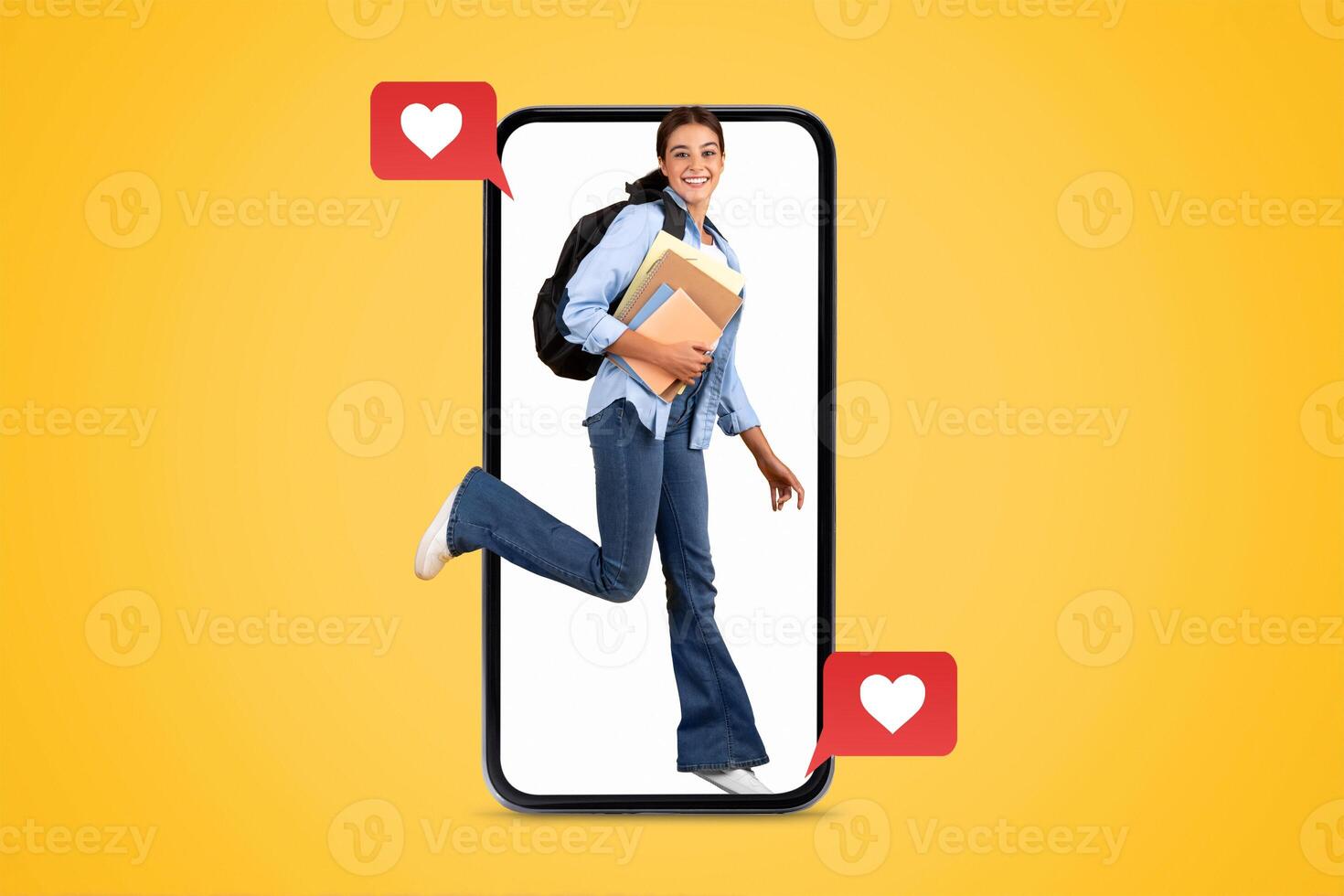 A young person is engaging with their smartphone, smiling while holding books. Colorful hearts emphasize the theme of love and social media connections during Valentine's celebrations. photo