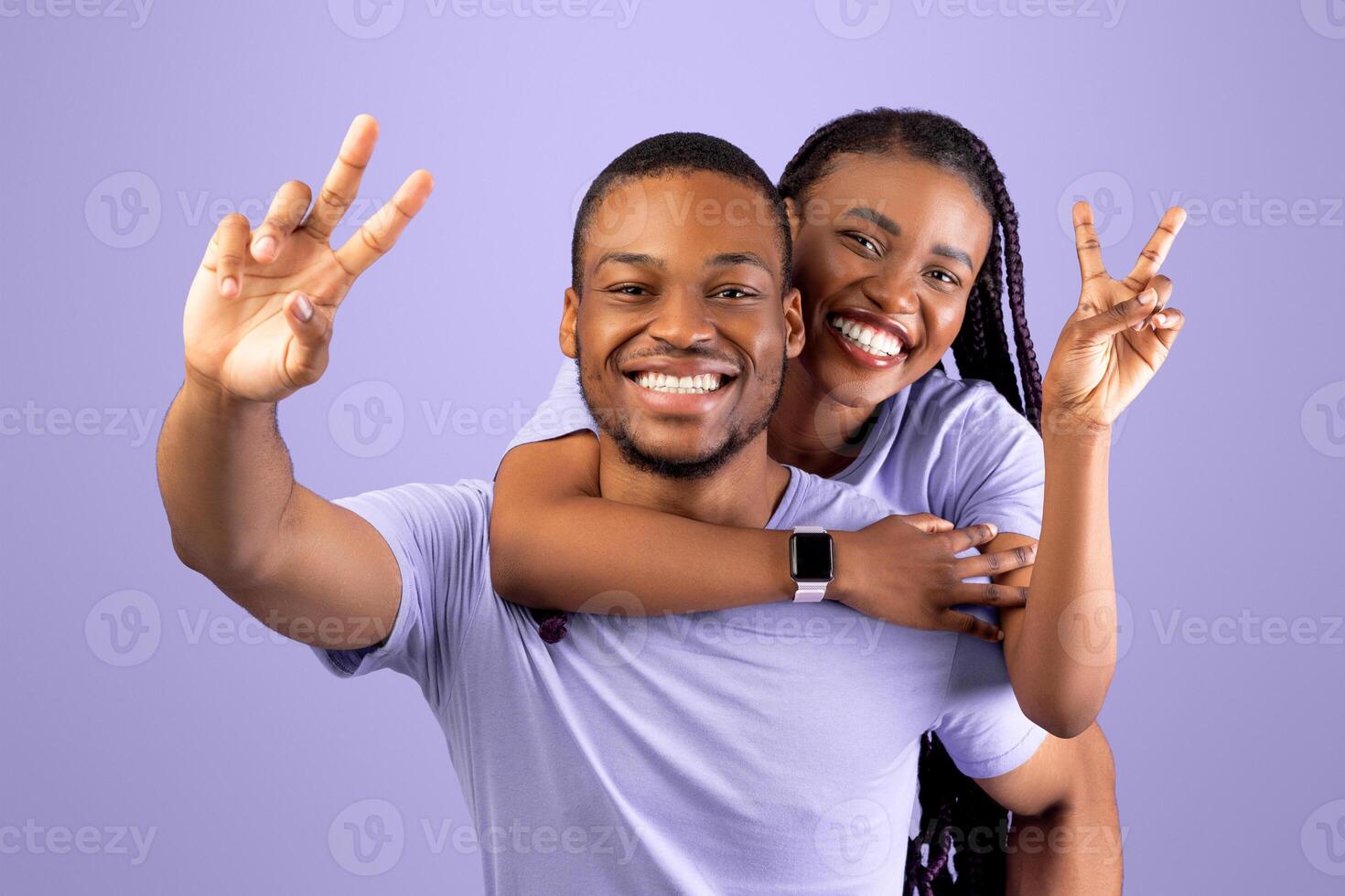Romantic Black Couple Having Fun Together, Showing V Peace Symbol Sign Gesture With 2 Two Fingers, Cheerful African American Guy Piggybacking Happy Girlfriend, Joyful Woman Riding On Guy's Back photo