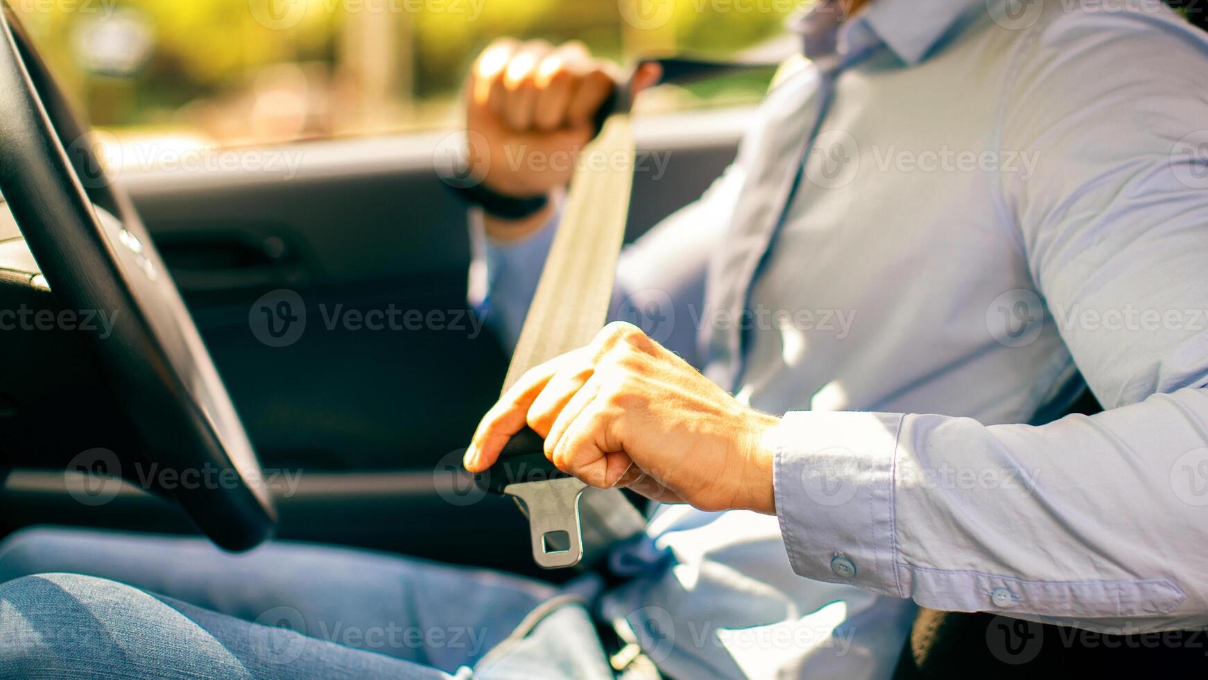 Cropped of arab guy in formal outfit fastening automobile seatbelt, closeup of middle-eastern man entrepreneur driving nice car, going to office, sde view, copy space. Safety driving concept photo