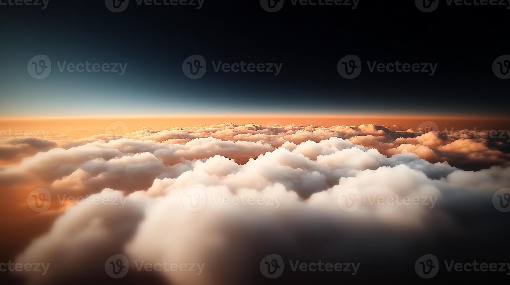 A breathtaking aerial view of soft clouds illuminated by a warm sunset over the horizon photo