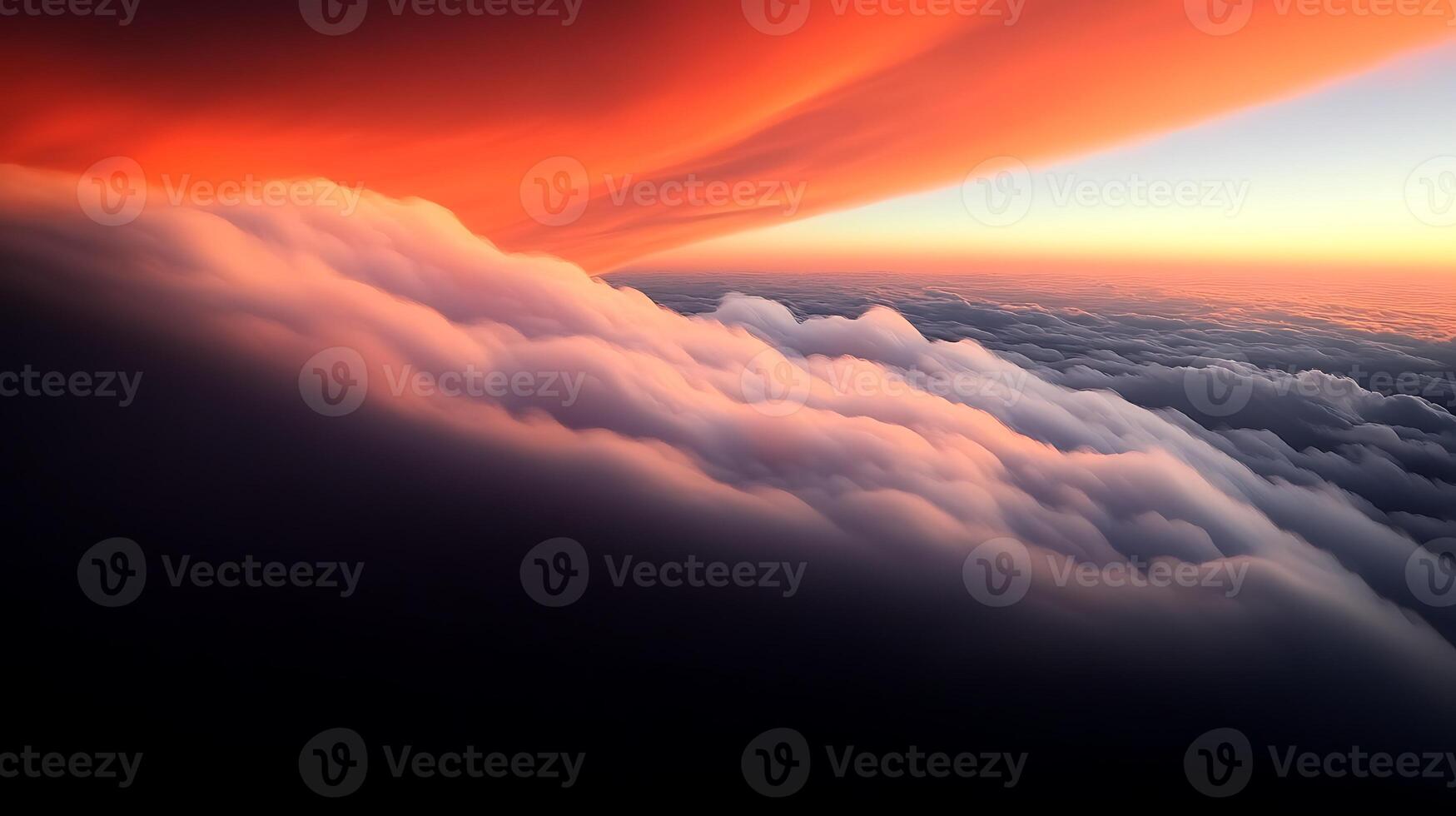 A breathtaking aerial view of vibrant orange and pink clouds at sunset above a serene horizon photo