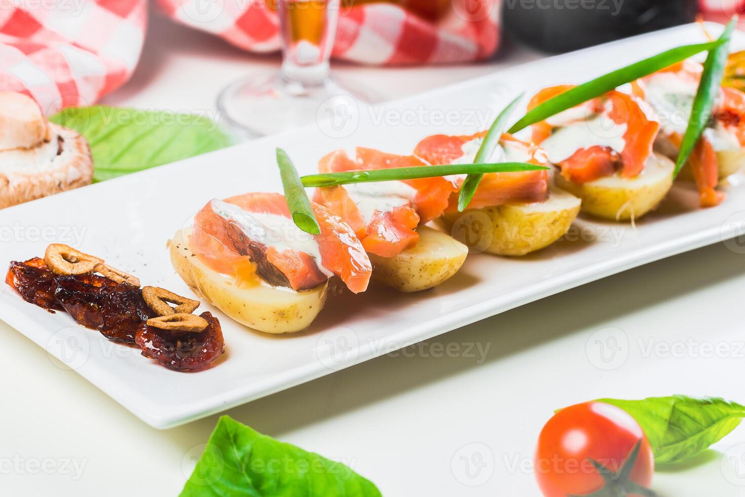 Delicious appetizer featuring smoked salmon and fresh vegetables served in a cozy dining setting photo
