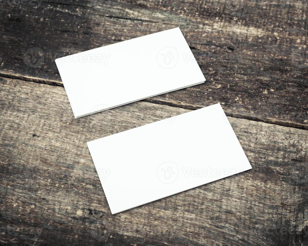 Blank business cards placed on a rustic wooden table ready for design and personalization photo
