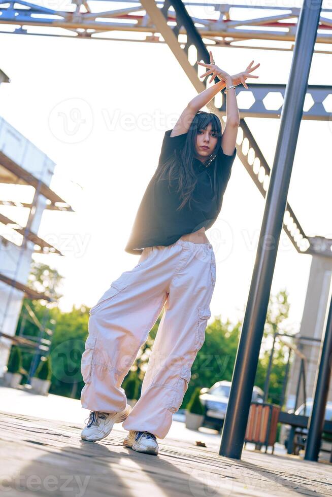 Dance performance under late afternoon light in an urban setting with a stylish outfit photo