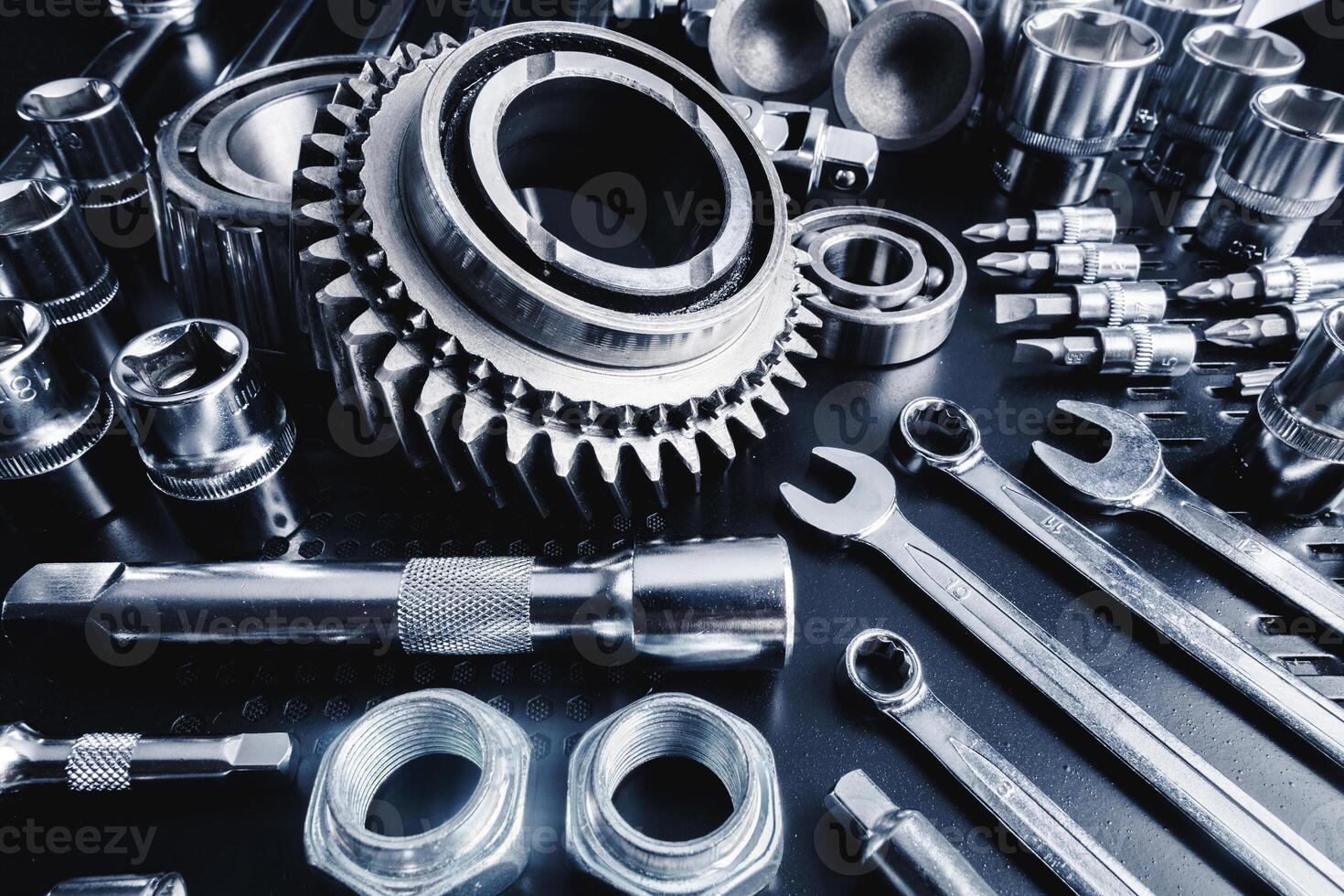 Tools and gears arranged on a workbench showcasing precision engineering and craftsmanship in a workshop setting photo