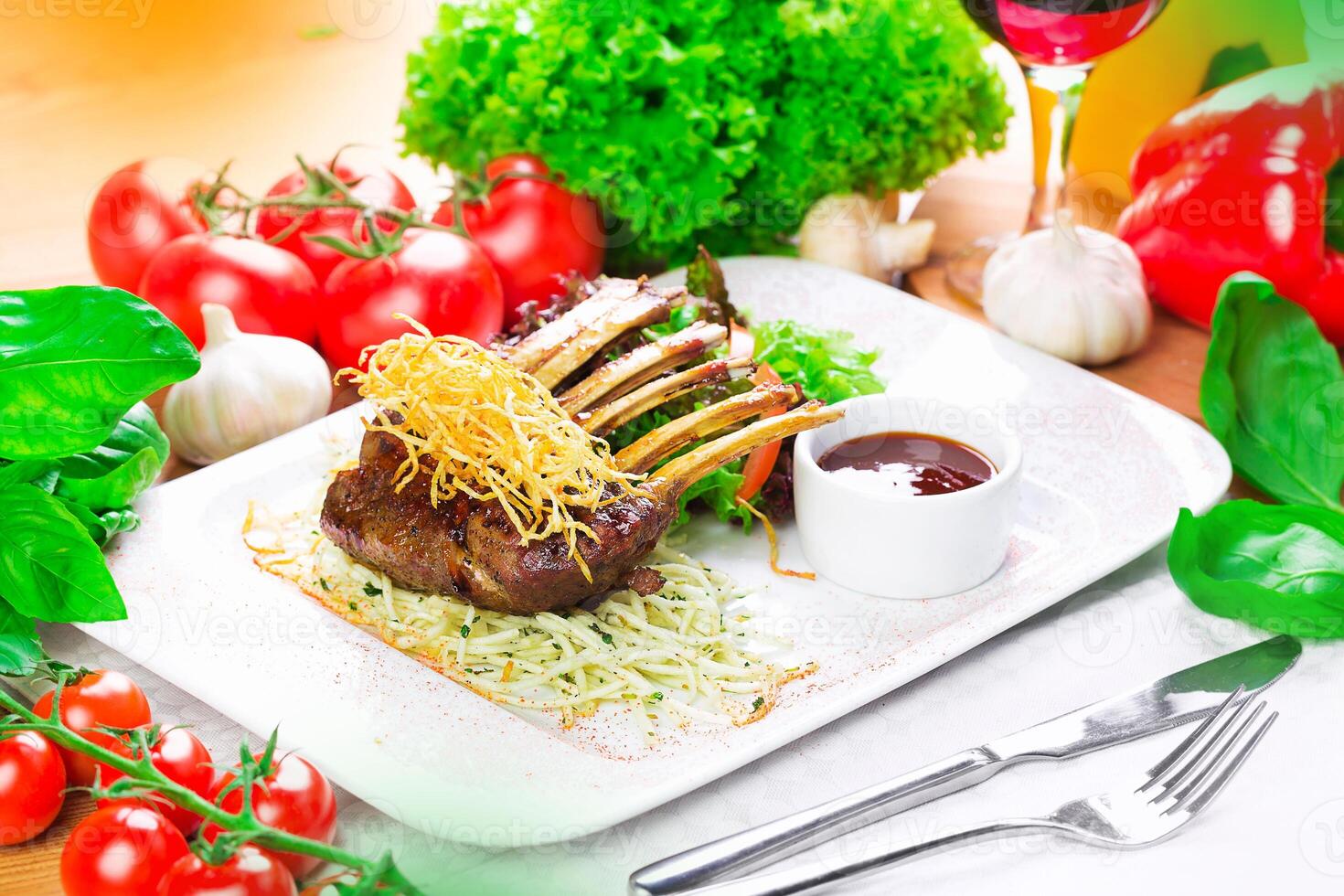 Exquisite lamb chop dish served with fresh vegetables on a classic white plate photo