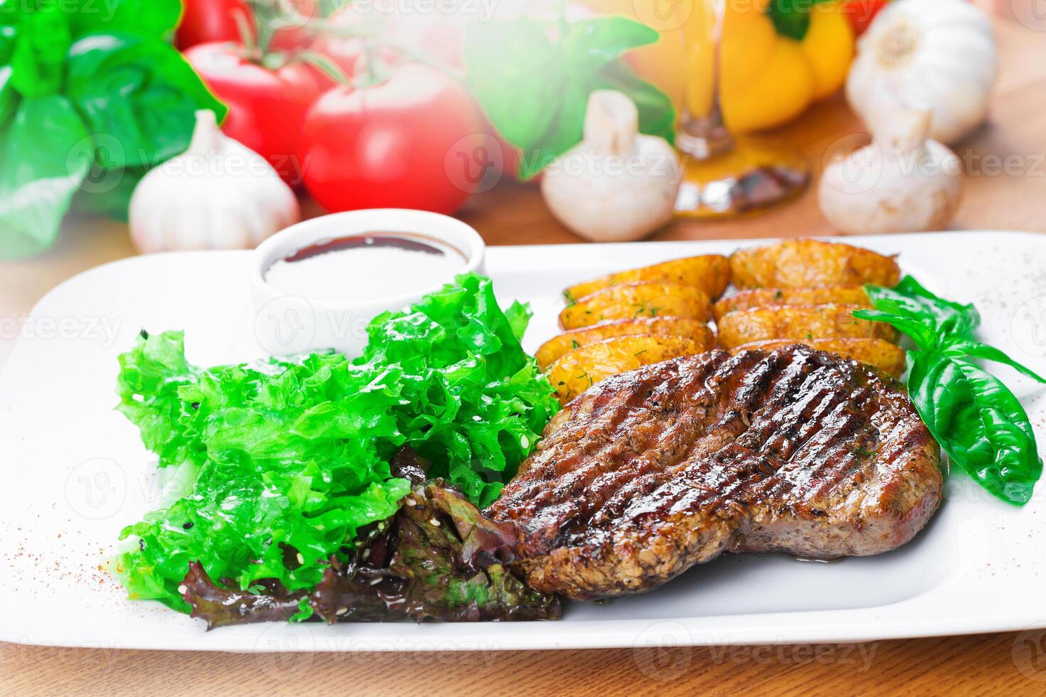 Grilled steak with vegetables and garnishes served on a white plate in a cozy restaurant setting photo