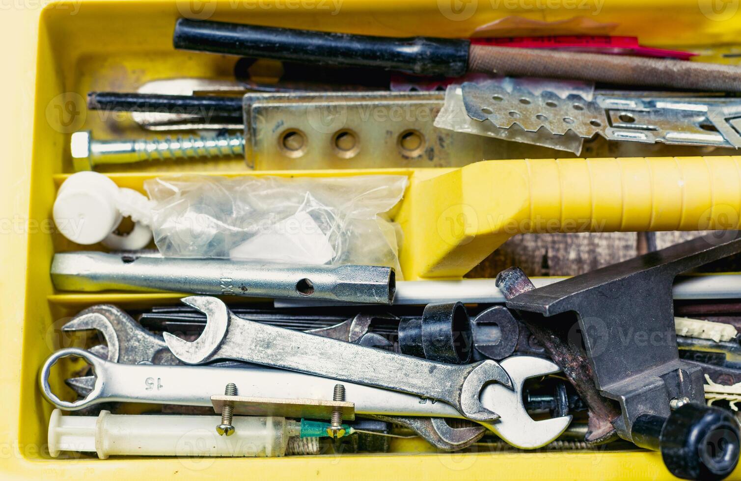 Toolbox filled with various hand tools and equipment for DIY projects at home or workshop photo
