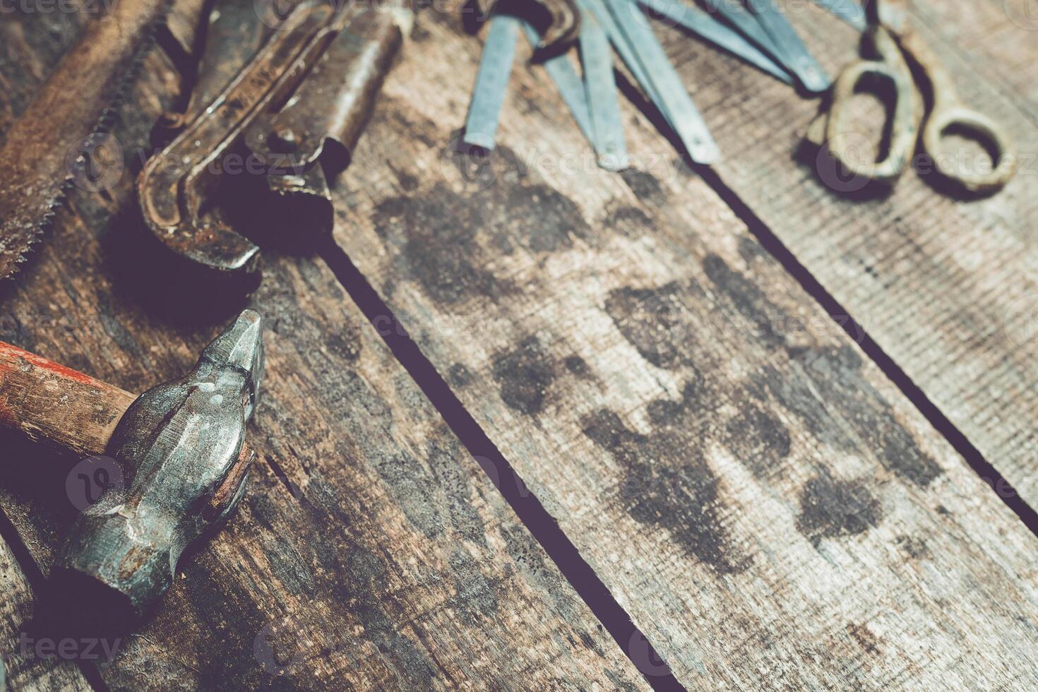 Rustic workshop tools arranged on a wooden bench showcase craftsmanship and creativity in a working space photo