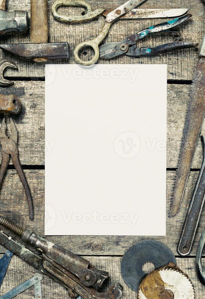 Collection of vintage tools on a rustic wooden table with a blank space for customization photo