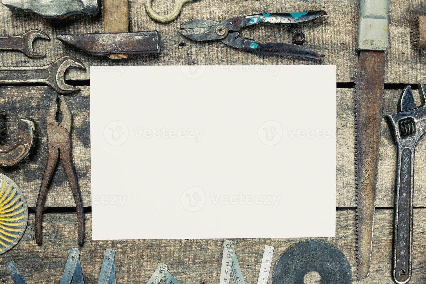 Tools laid out on wooden surface ready for repair work or crafting project during the daytime photo