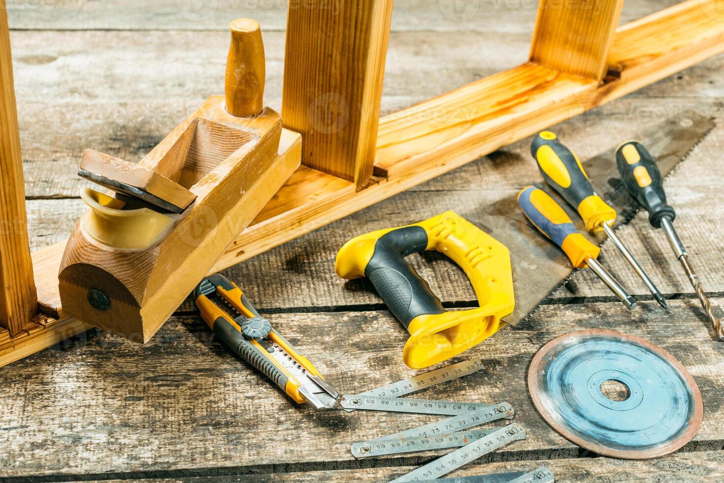 Tools scattered on a rustic wooden surface for a woodworking project in a cozy workshop photo