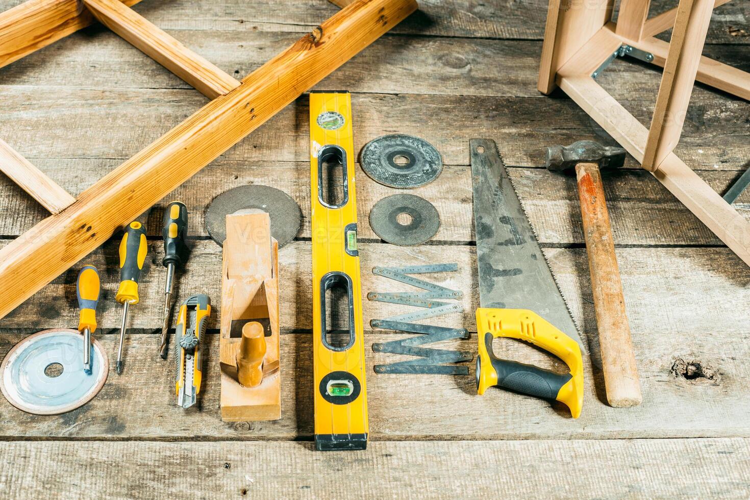 Tools and equipment arranged on a wooden surface for DIY projects in a bright workshop setting photo