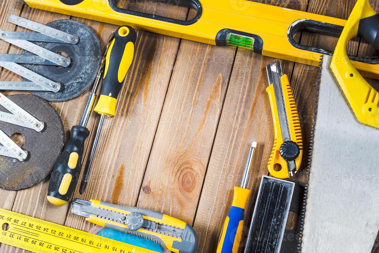 Work tools arranged on a wooden surface for home improvement and DIY projects photo