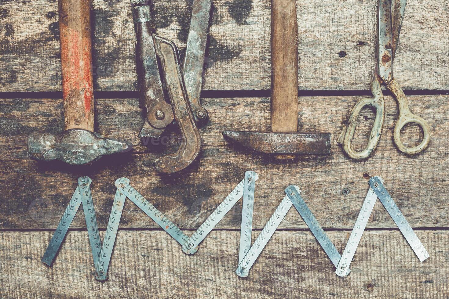 Tools arranged on a wooden surface showing craftsmanship and manual work in a rustic workshop setting photo