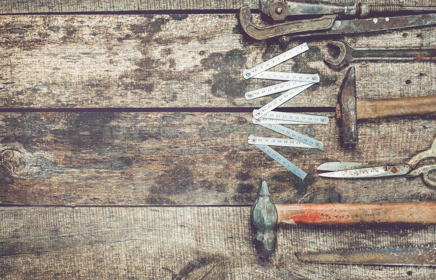 Vintage hand tools arranged on a wooden workbench showcasing craftsmanship and tool maintenance in a rustic environment photo