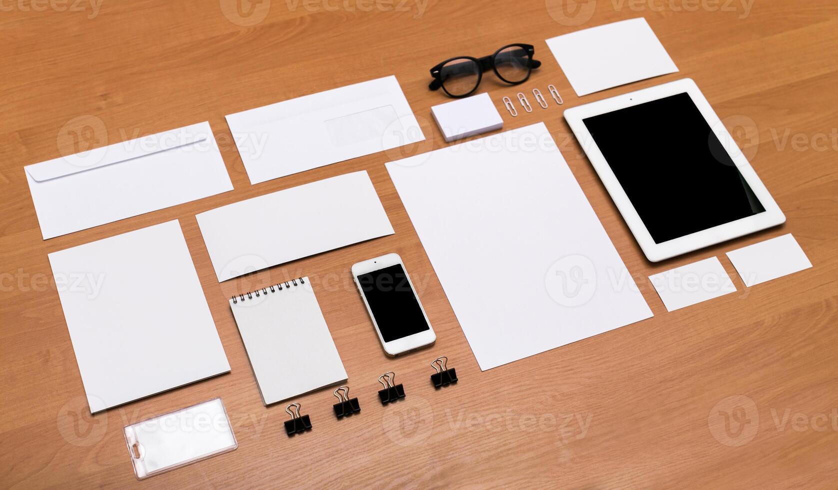 Workspace arrangement with stationery, digital devices, and blank materials for creative projects and organization photo