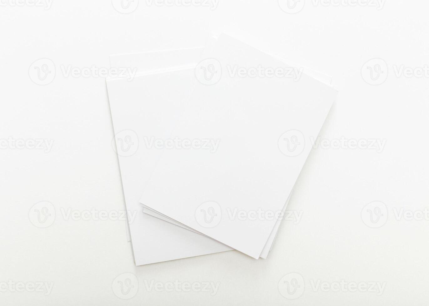 Blank sheets of white paper stacked on a clean surface ready for creative projects and note-taking at any time photo