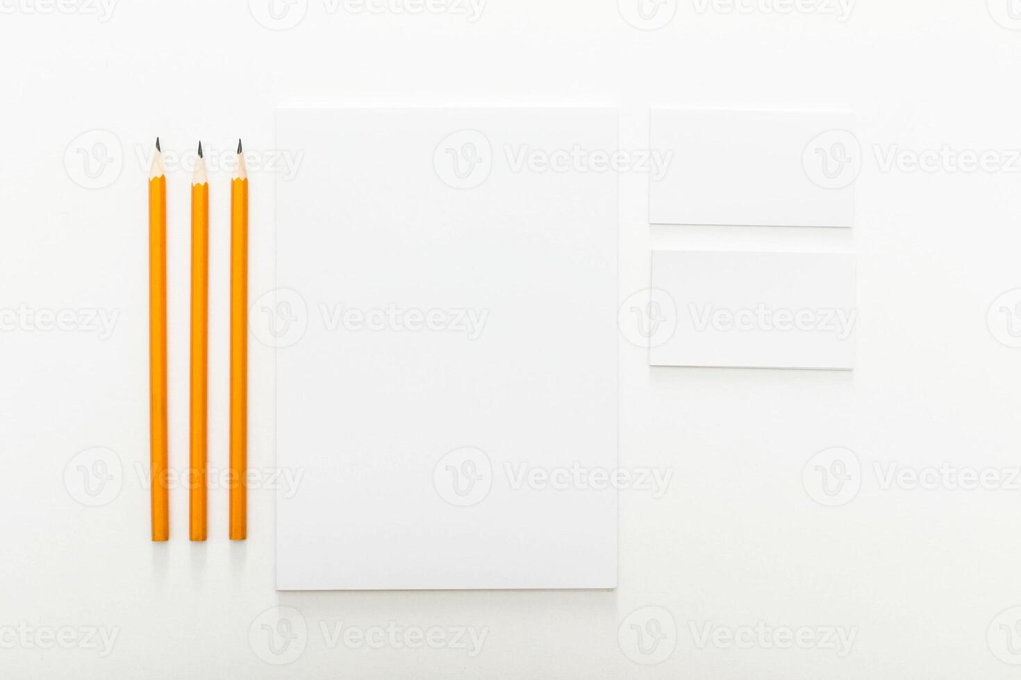 Blank canvas and orange pencils ready for creative expression at an art studio workspace photo