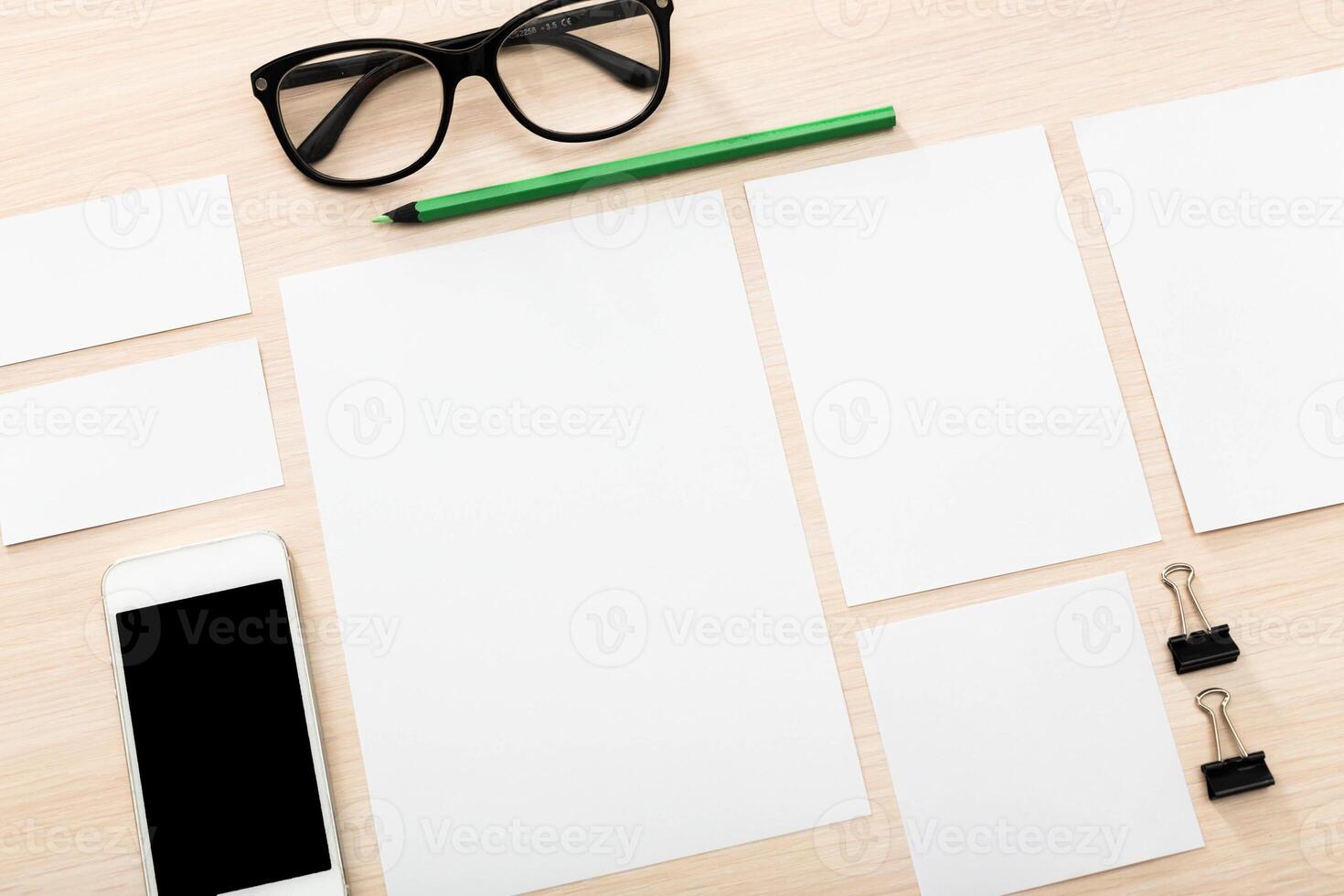 Blank workspace layout with stationery and smartphone on wooden desk for creative planning and organization photo