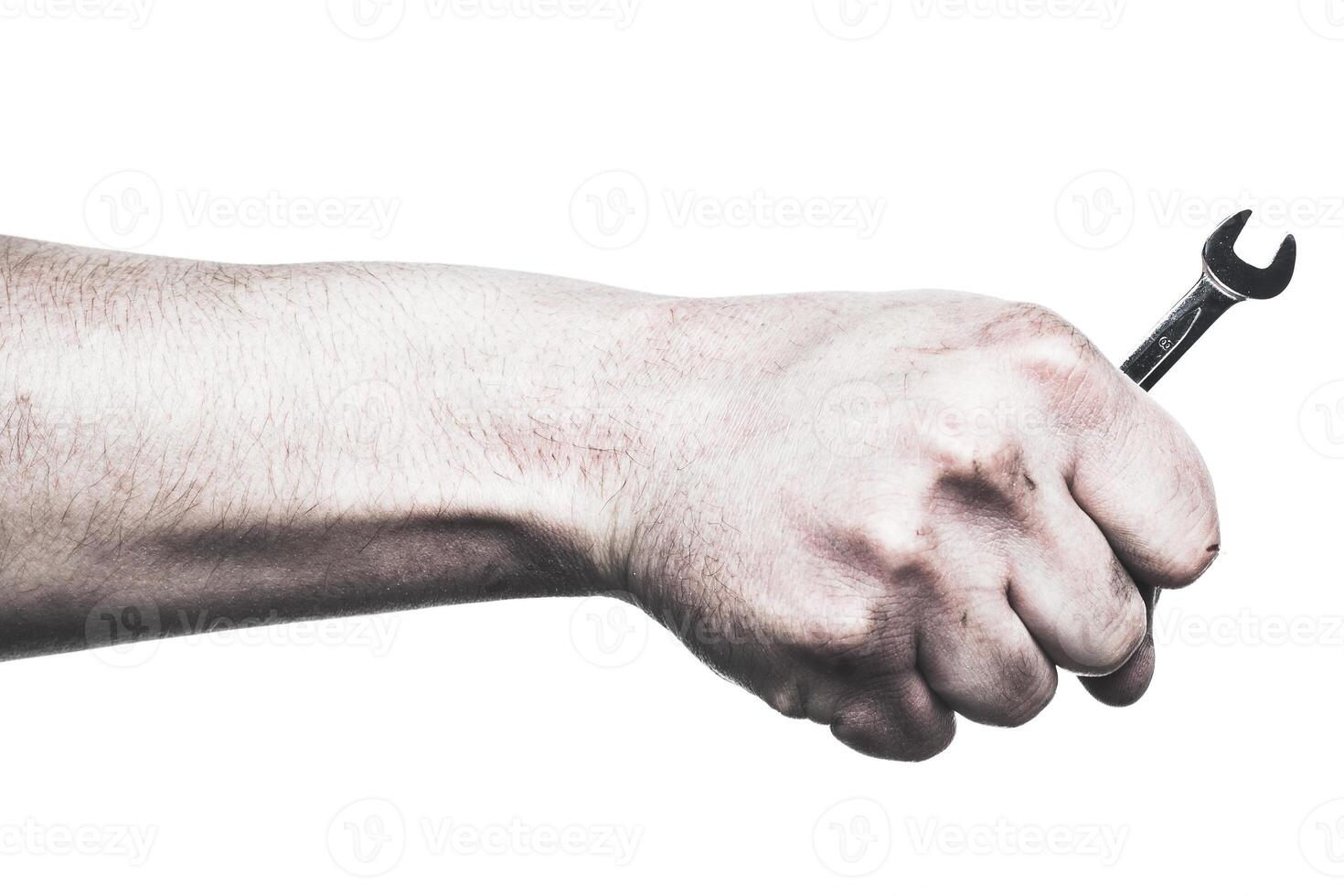 Hand gripping a wrench in a strong pose at a workspace focused on mechanical repair photo