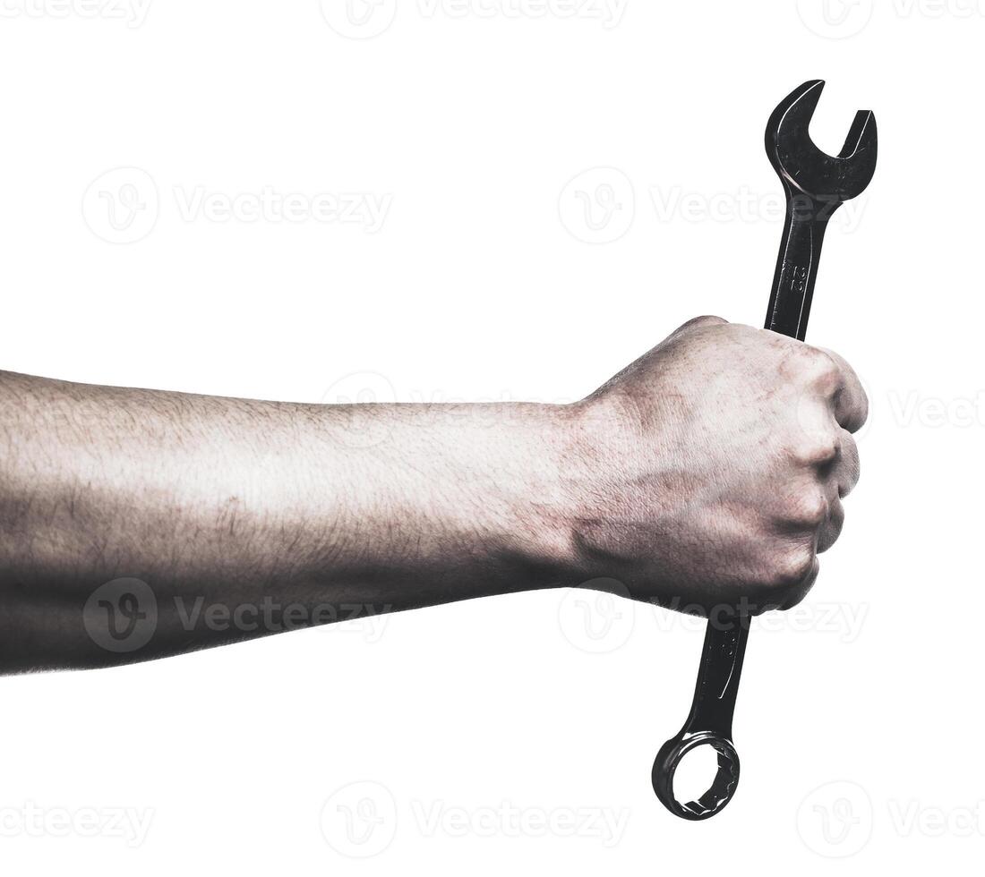 Hand gripping a wrench ready for mechanical work on a machine photo