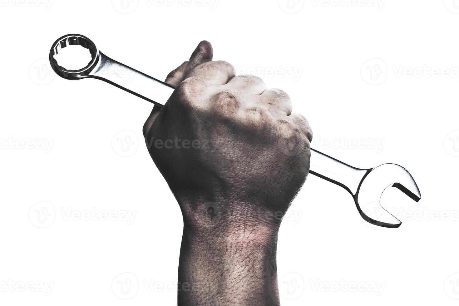 Strong hand gripping a wrench symbolizes determination and craftsmanship in a workshop environment photo