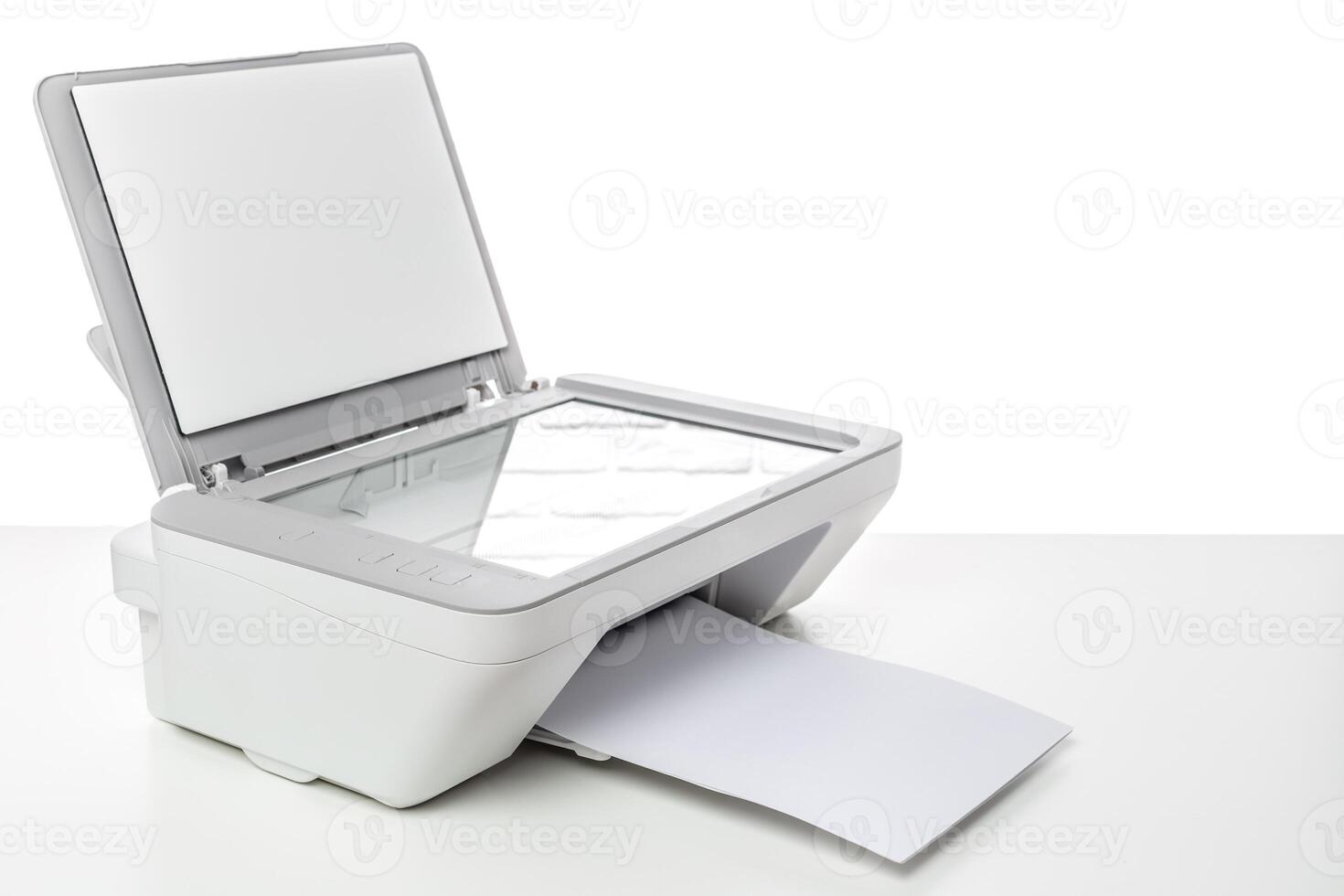 Office printer with scanning function sitting on a desk ready for use during the day photo