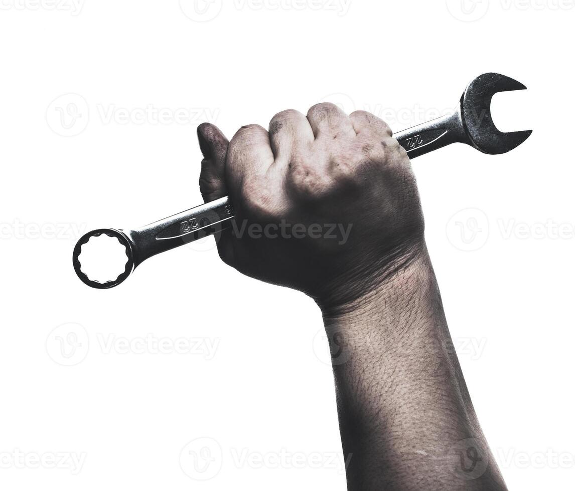 Skilled hand gripping a wrench, showcasing strength and determination during a repair task photo