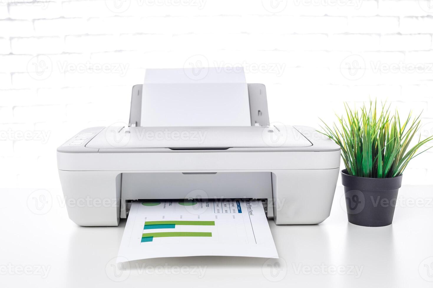 Printer in a bright office environment producing printed documents with colorful charts and graphs photo