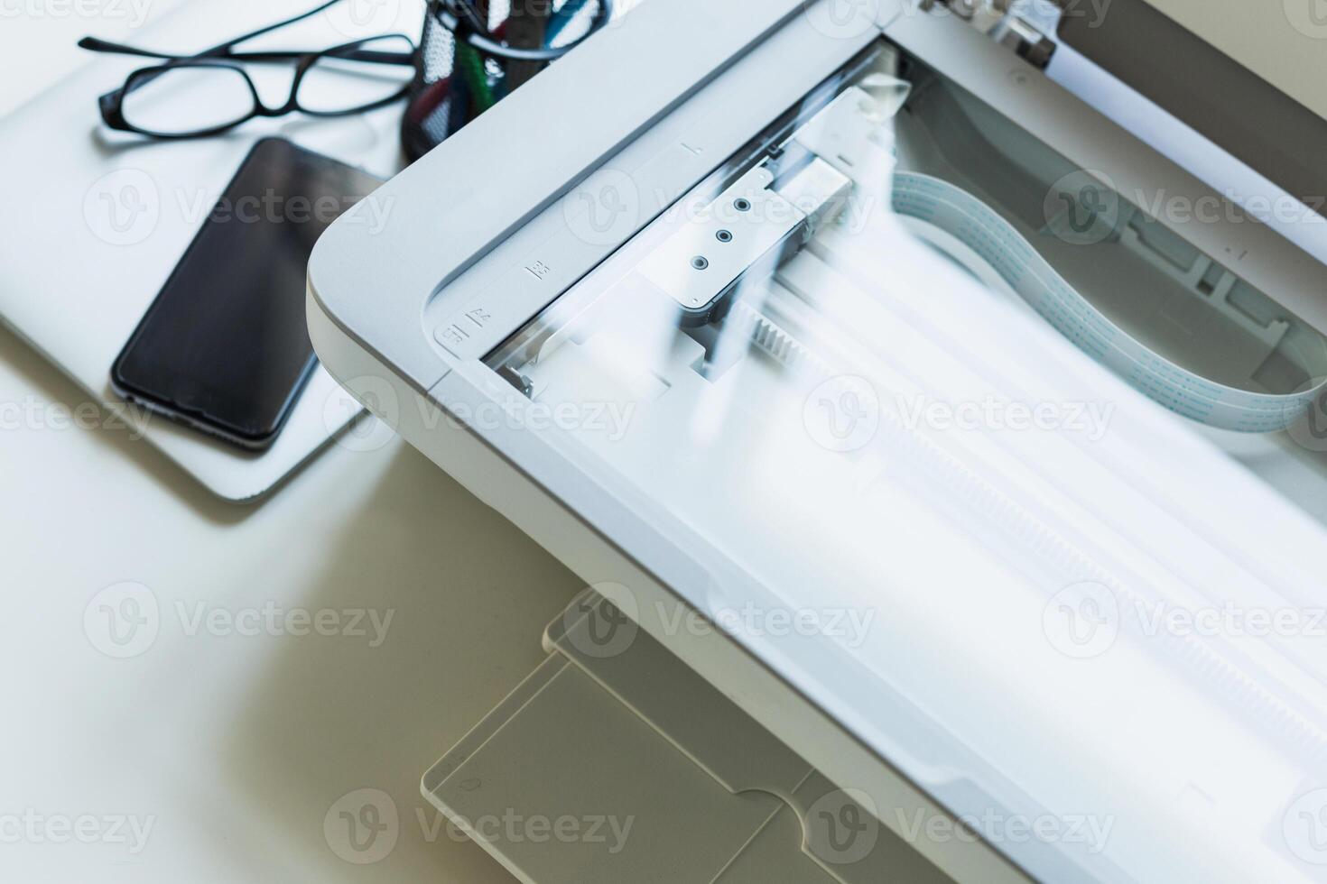 Scanner and office supplies on a work desk during a busy day focused on productivity and organization photo