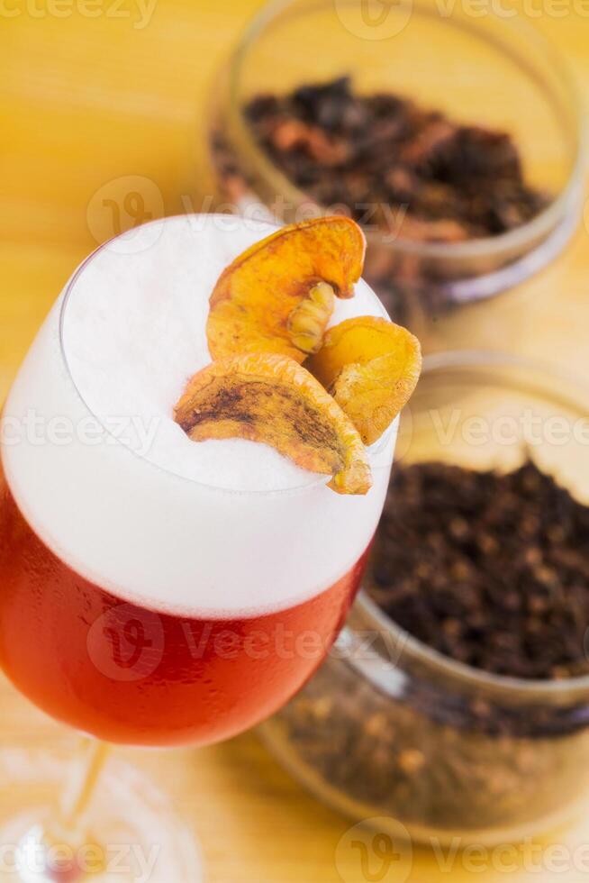 Refreshing cocktail with dried fruit garnish served at a vibrant bar during the evening photo
