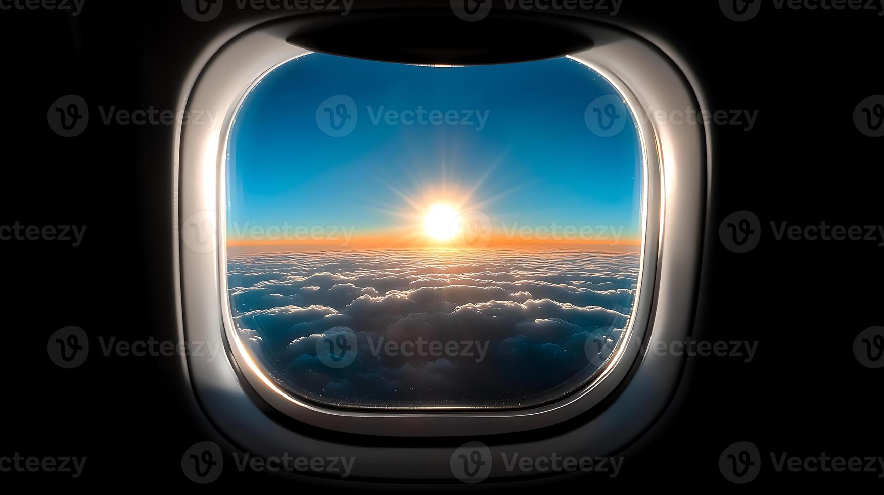 A breathtaking sunrise viewed from an airplane window above the clouds during flight photo