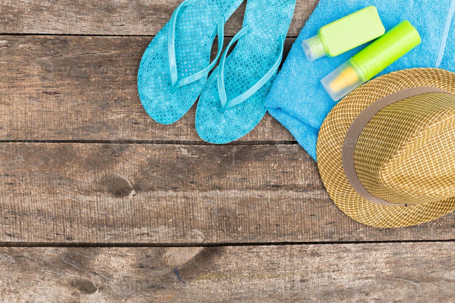 Beach essentials laid out on a wooden surface ready for a sunny day of relaxation and fun at the seaside photo