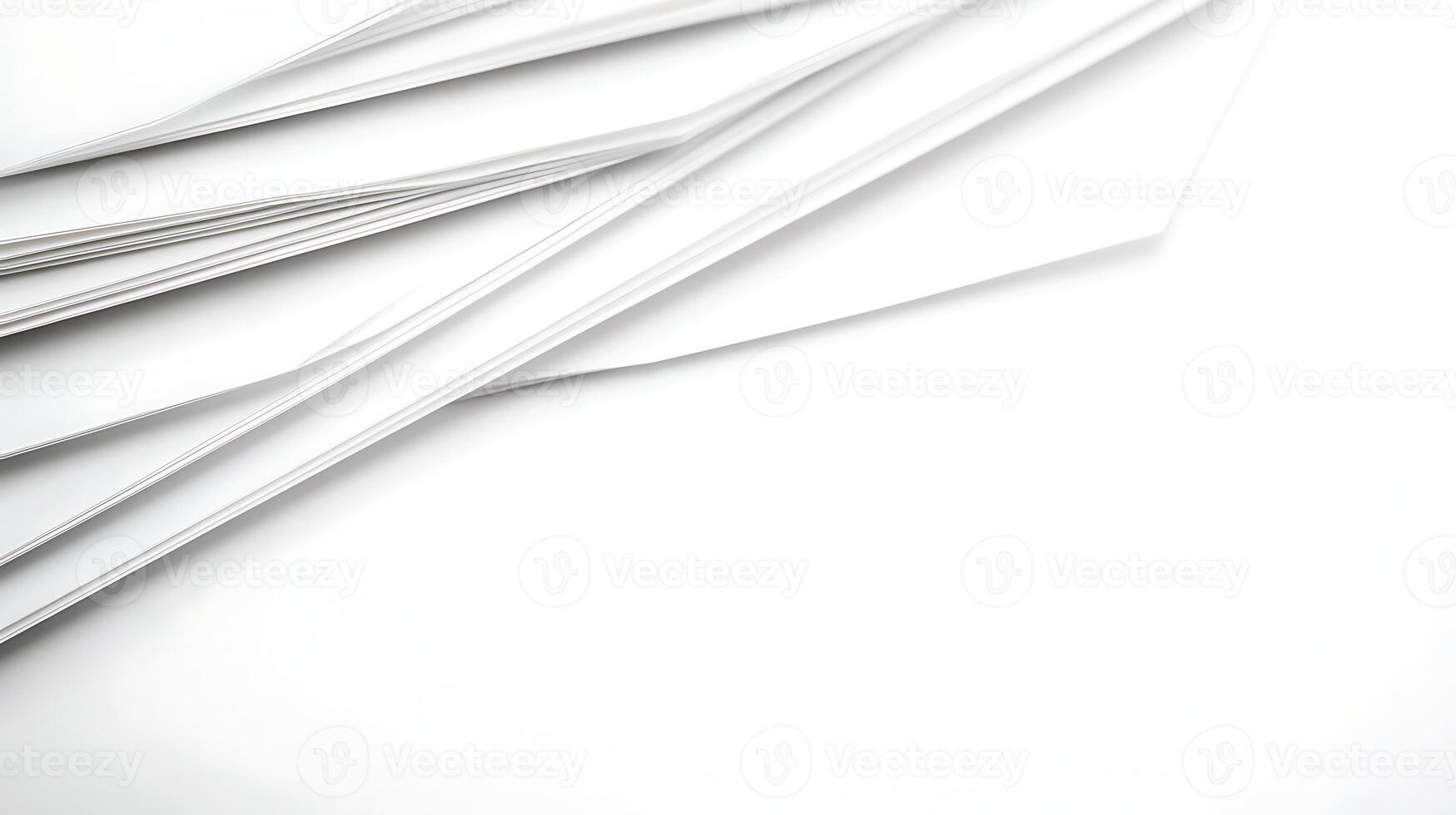 A collection of white sheets of paper arranged at an angle on a clean surface, ideal for backgrounds photo
