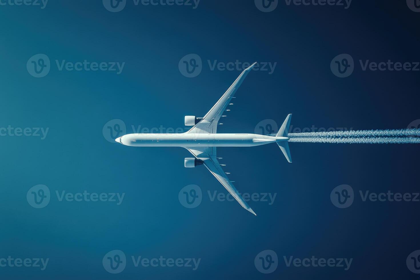 Airplane soaring high with vapor trail in blue sky photo