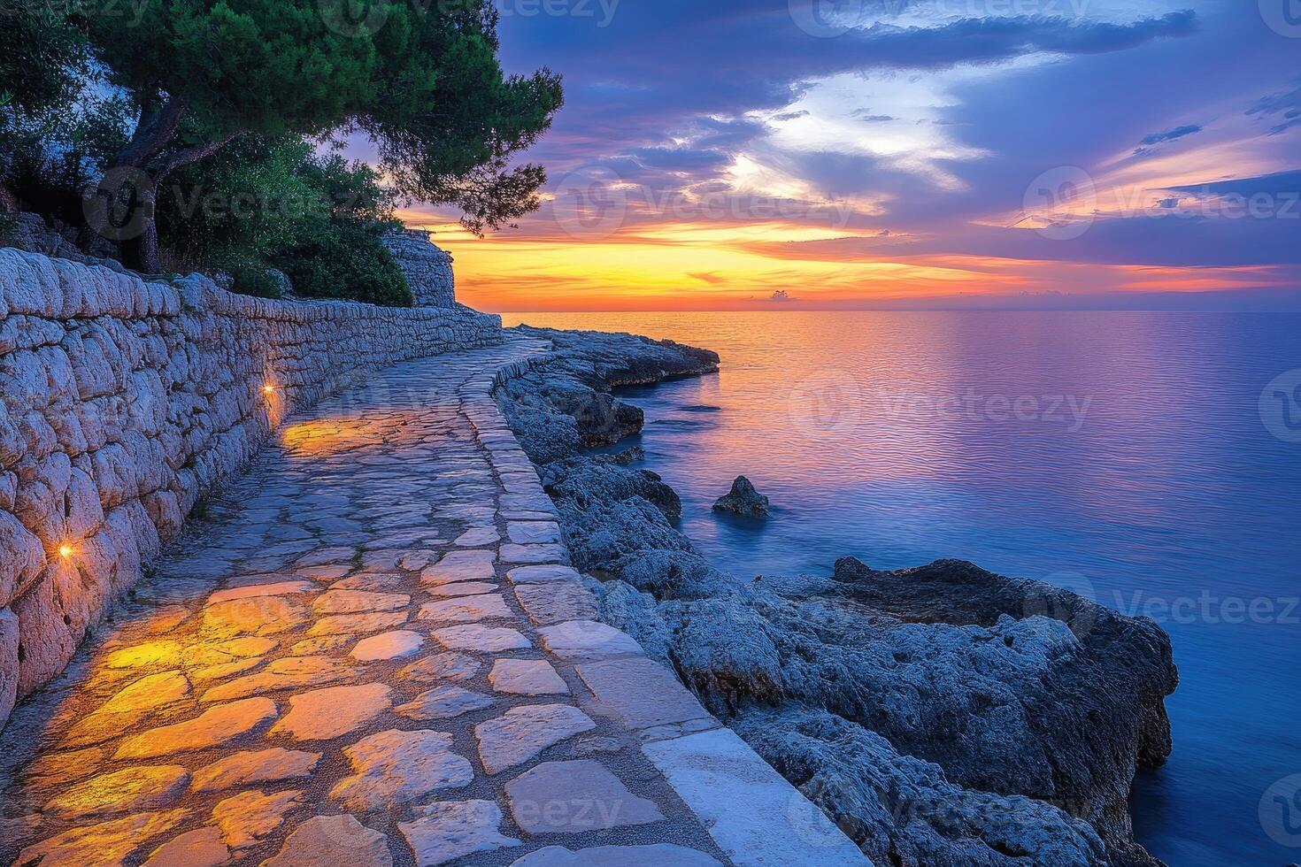 Stunning sunset over rocky coastal pathway. photo