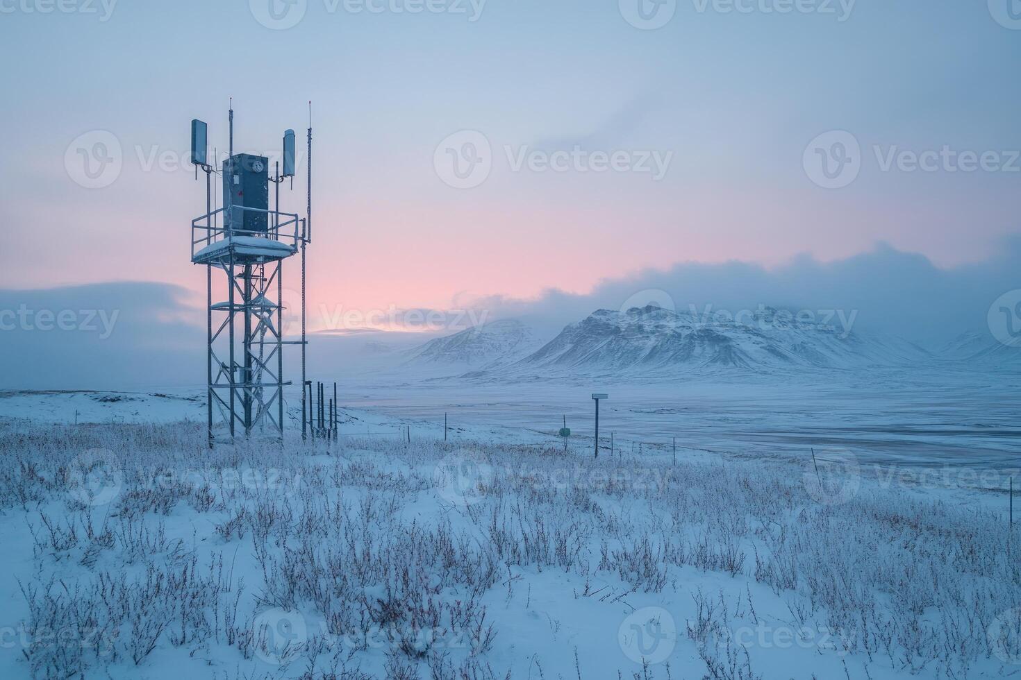 Telecommunication tower standing in snowy landscape at dawn photo