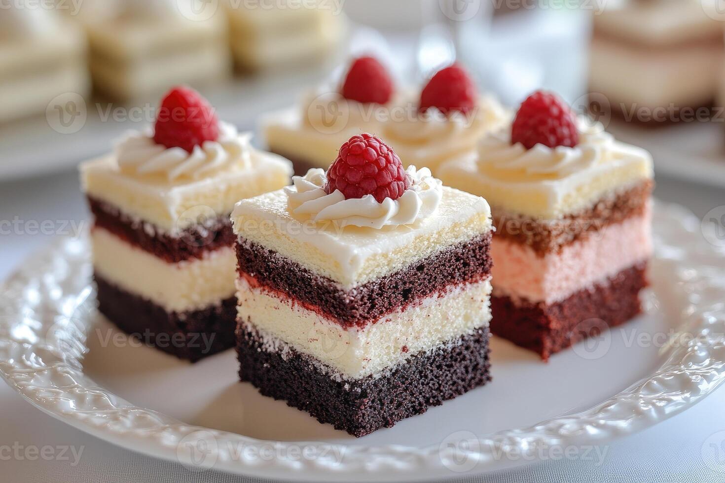Assorted miniature layered cakes with decorative toppings photo