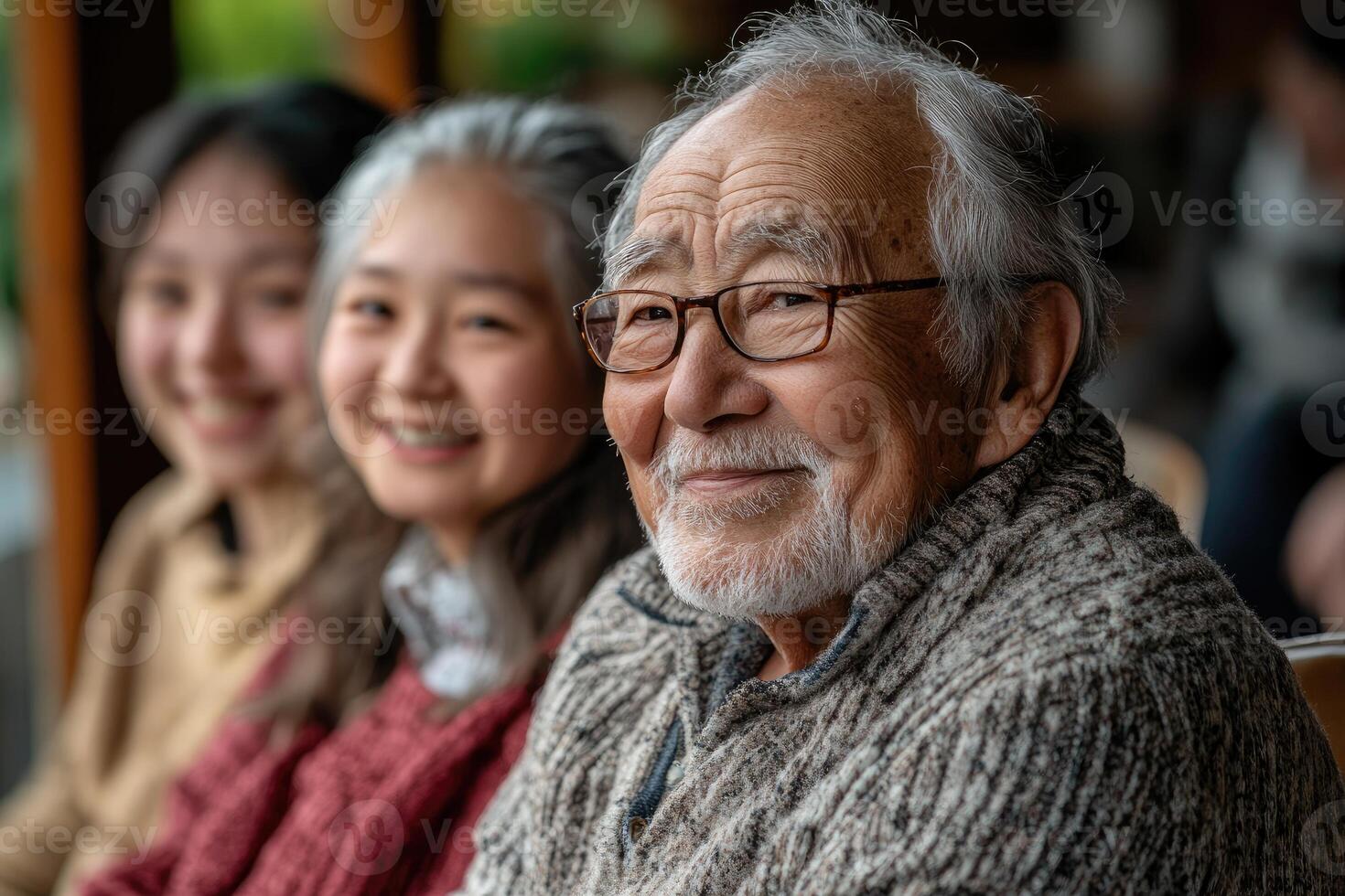 Portrait of smiling senior man with his family members in background photo