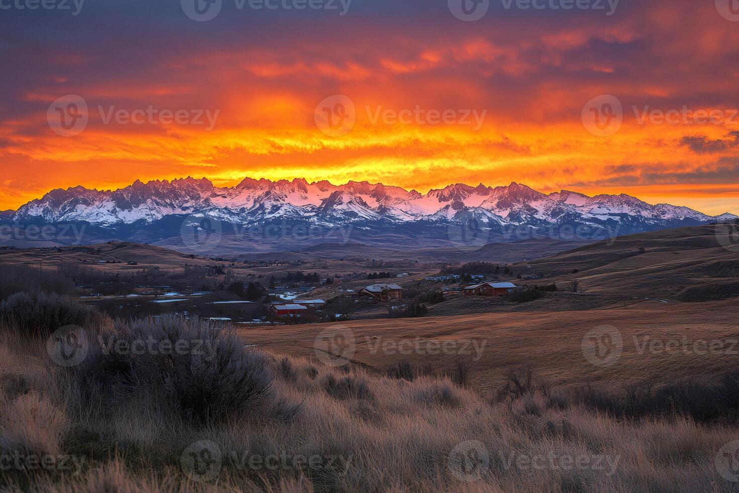 Sunrise painting the Sawtooth Mountains in Stanley, Idaho, in orange and red photo