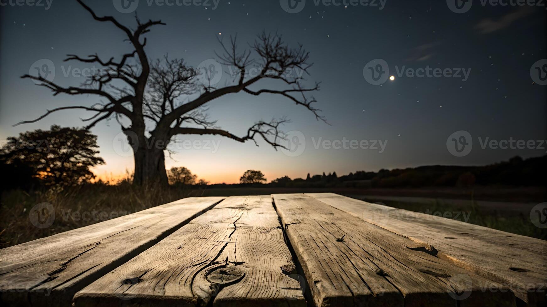 Rustic Wooden Table Under Starlit Night Sky with Dead Tree Silhouette photo