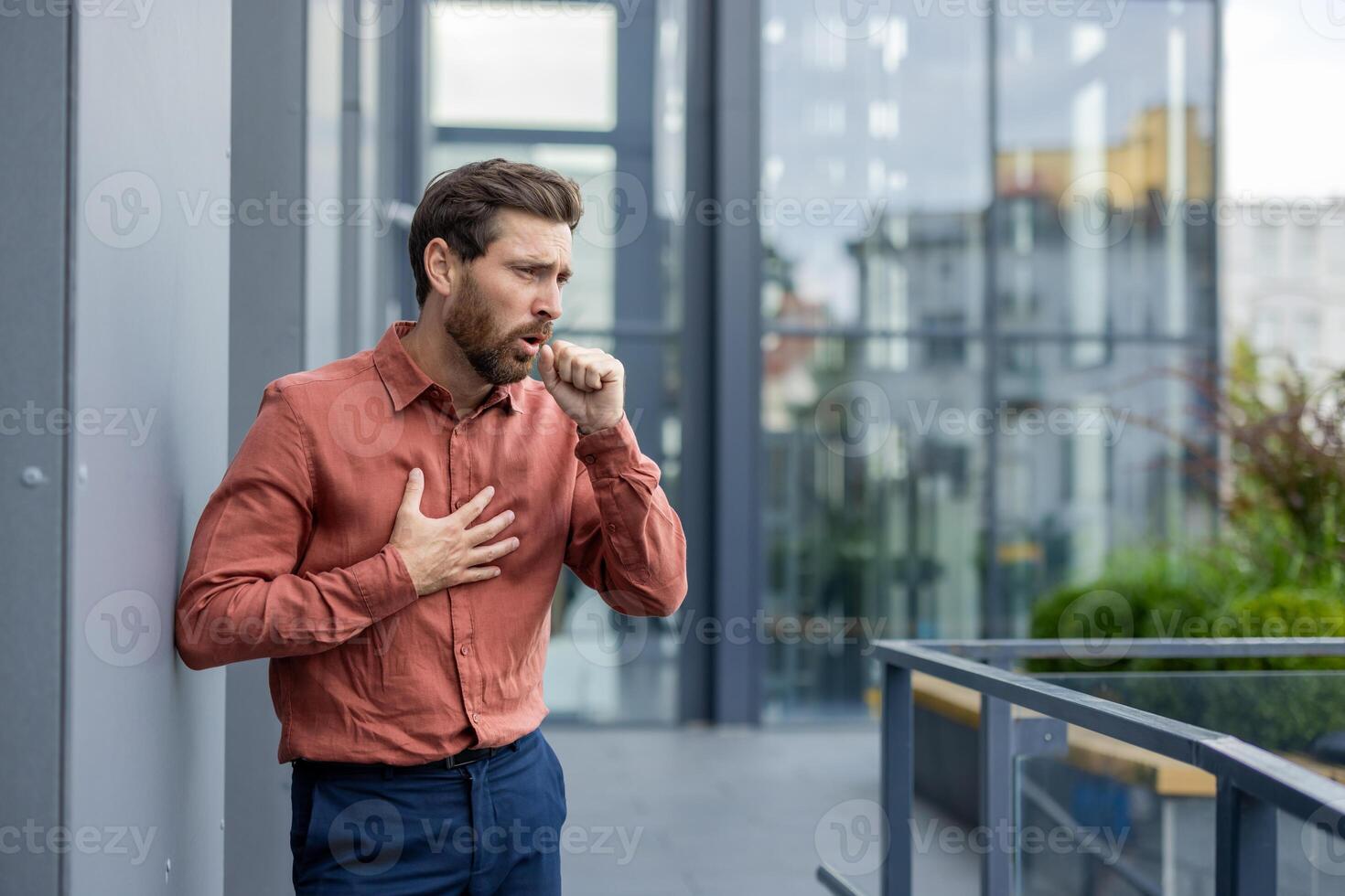 Mature man coughing with visible discomfort. Indicates possible respiratory issues or illness symptoms. Health concept, concern visible on face. photo