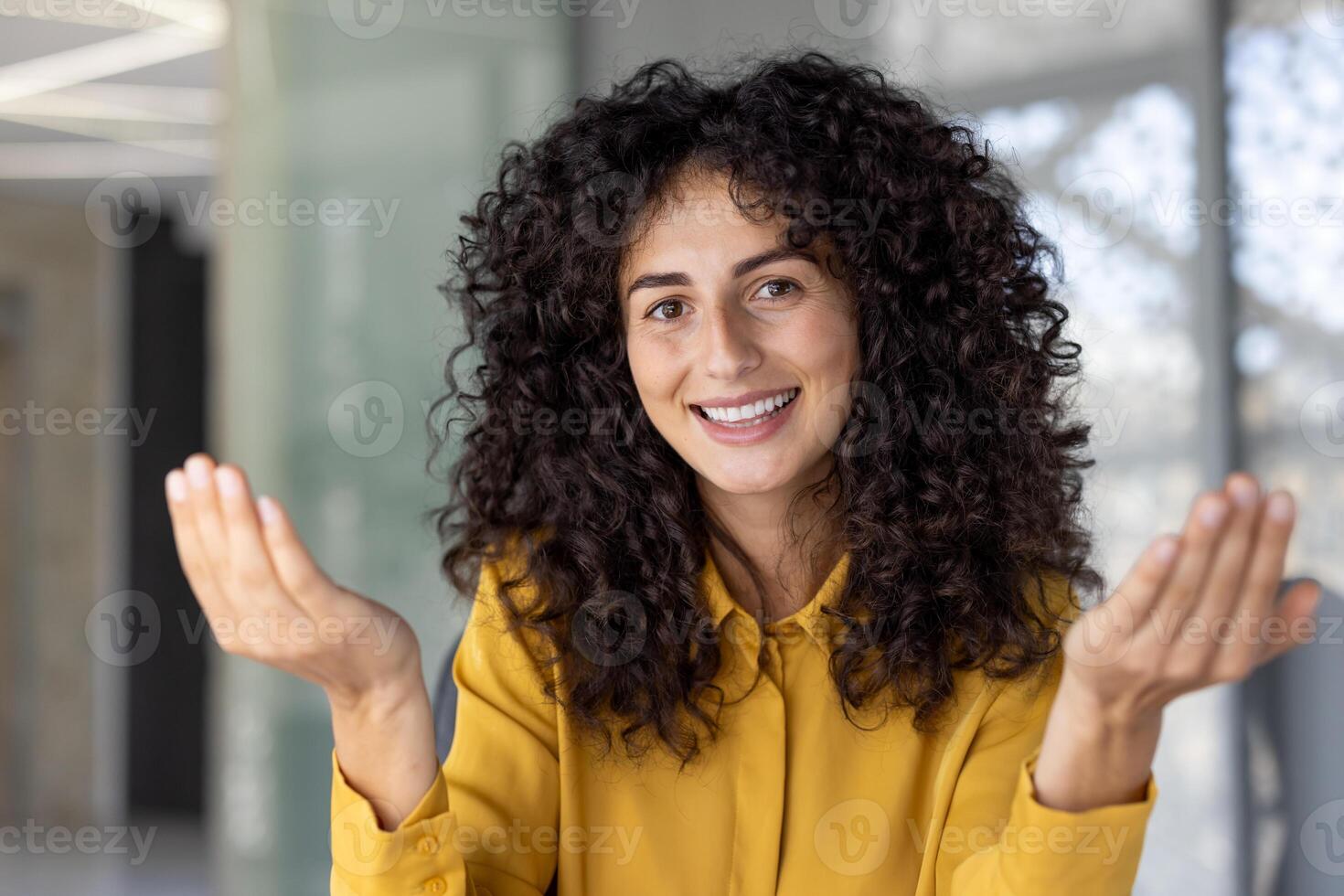 Webcam view, woman smiling happily and looking into camera, talking to colleagues and friends remotely using call, online meeting conference. Businesswoman inside office. photo