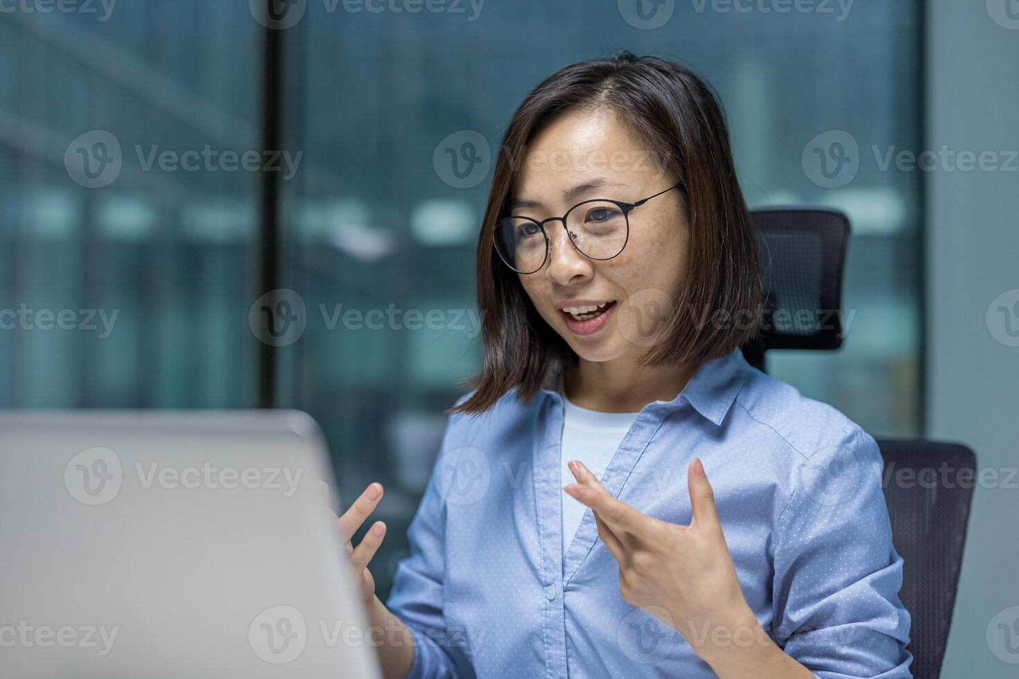call woman talking remotely with colleagues using laptop and online meeting, close up businesswoman smiling happily and gesturing with hands. photo