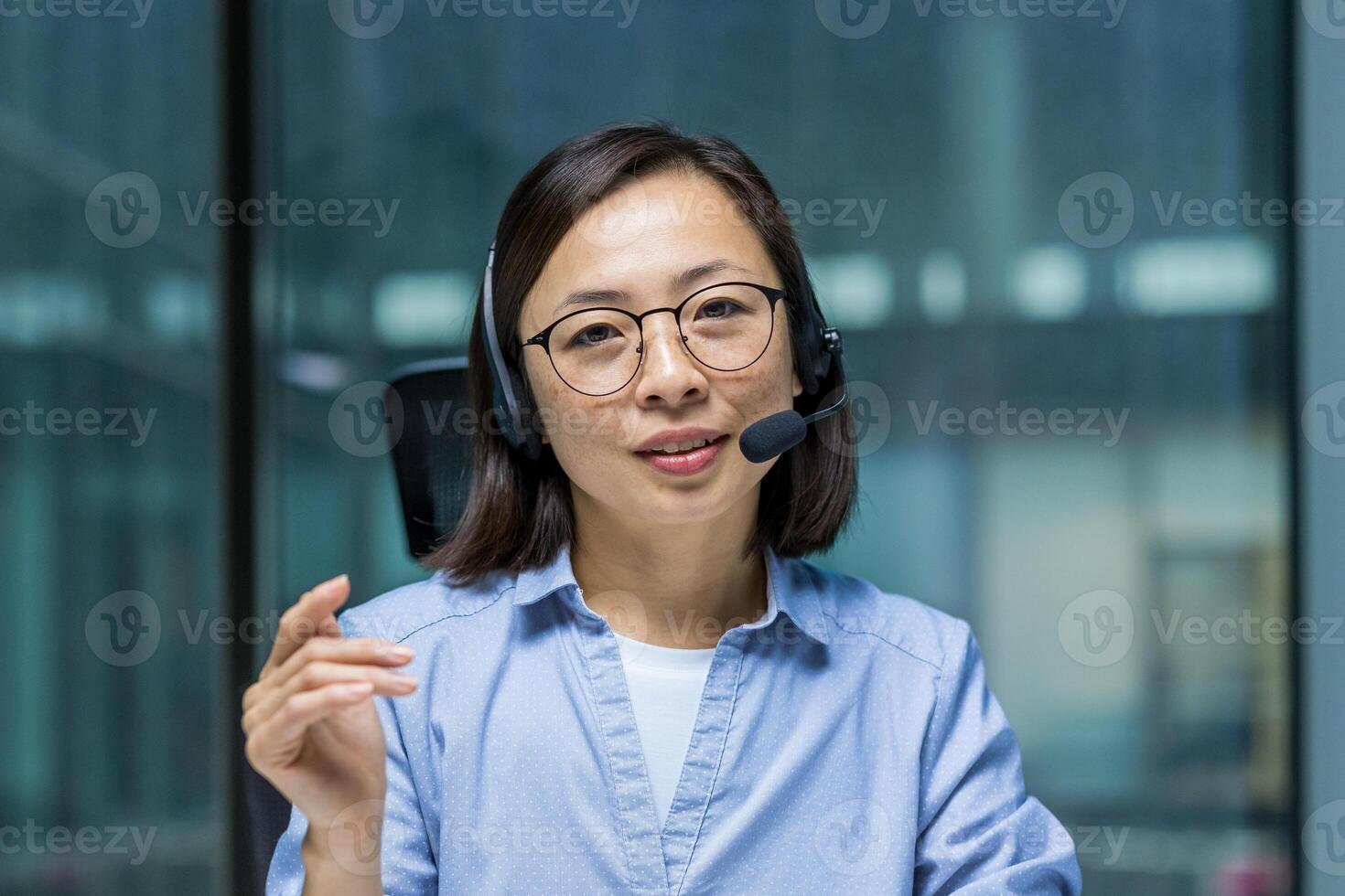 Asian woman wearing a headset engaging in a professional online meeting or call. She is communicating confidently and effectively, highlighting a productive and business-oriented atmosphere. photo